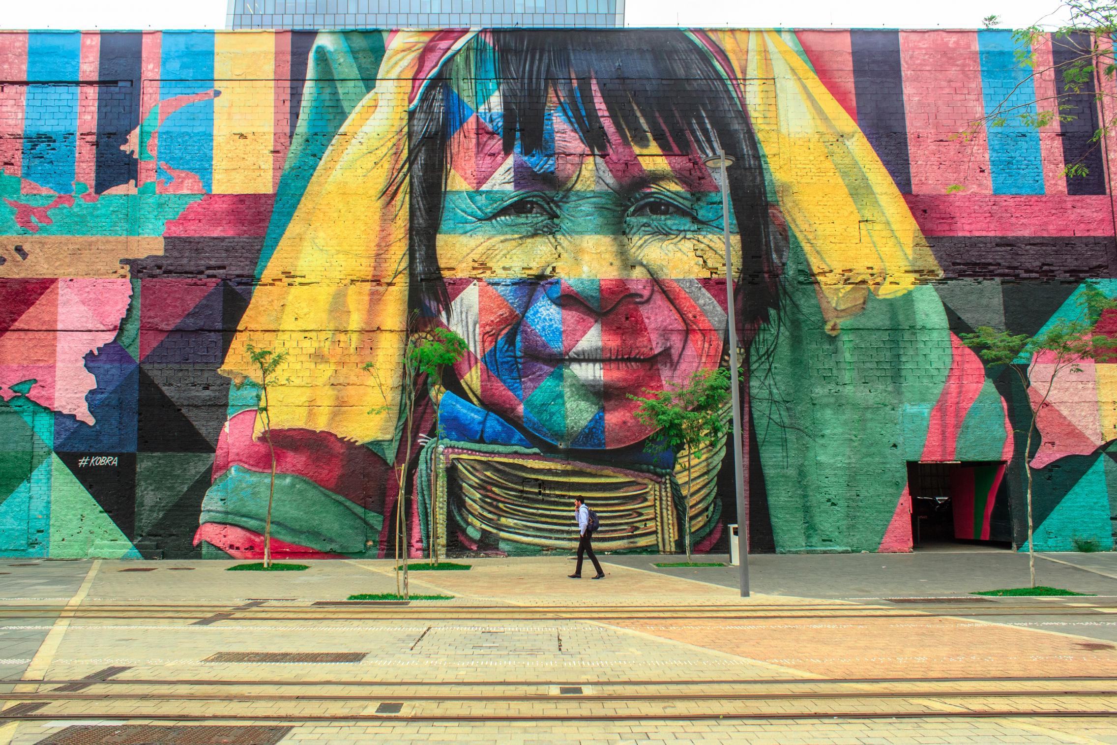 colourful womans face painted on building