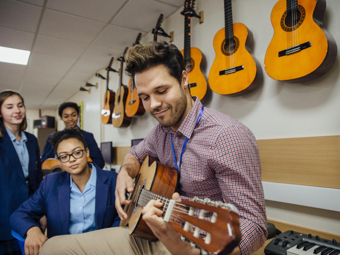 Music Teacher with guitar